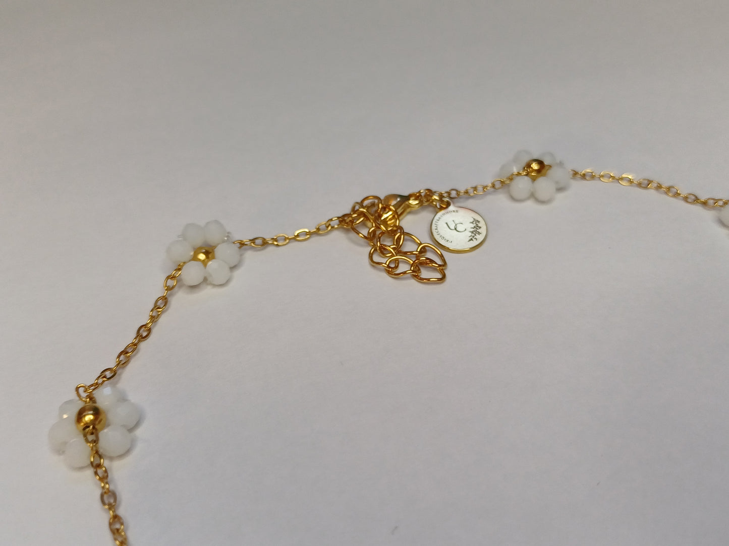 Golden flower mat wit ketting